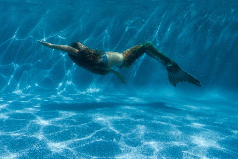 Mermaid learning how to swim in a pool