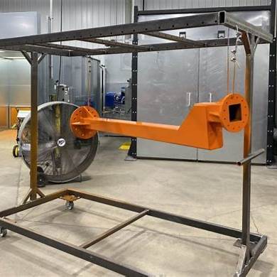 A rack mid‑way through powder‑coating preparation