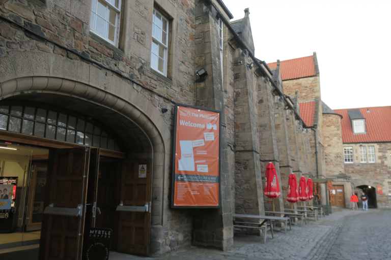 A view of the interior of the Pleasance Courtyard and its arched entrance.