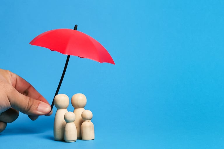 Hand holding a red umbrella over wooden peg dolls to represent family life insurance coverage.