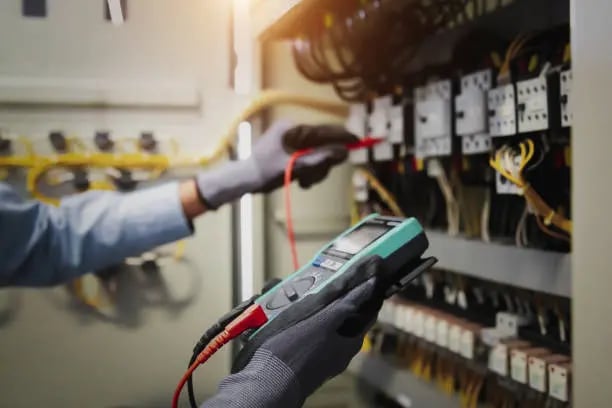 a man in gloves and gloves holding a multi - function metered metered meter