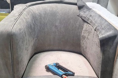 Gray velvet chair mid-reupholstery with tools on seat, showing custom work by Solo Home Decor.