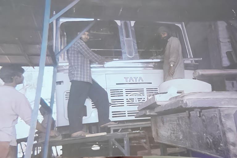 Old workshop photo showing a skilled worker fabricating a truck body at MS Engineering Works, Sonipa
