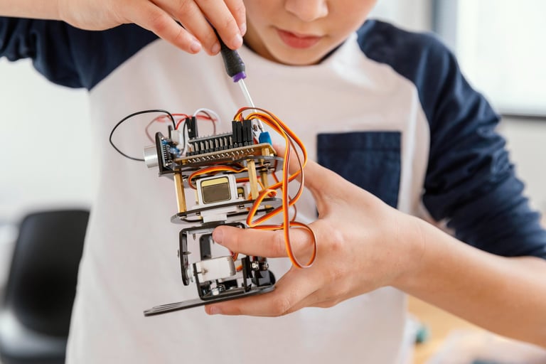 A student connects electronics and custom 3D-printed parts to an advanced robotics project.