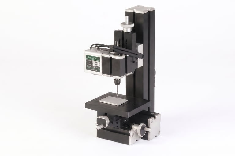Operating a hand press drill to create clearance holes for robotics.