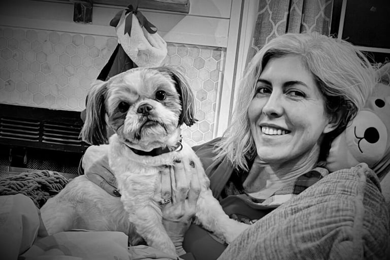 woman holding dog and smiling