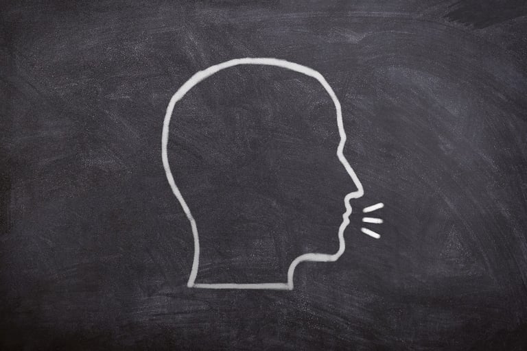 a drawing of a head talking on a chalkboard