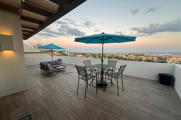 Casa Janet patio occean view with tables and umbrellas 