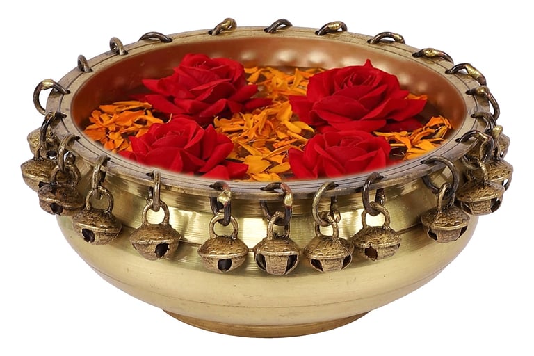 a bowl of flowers in a gold bowl