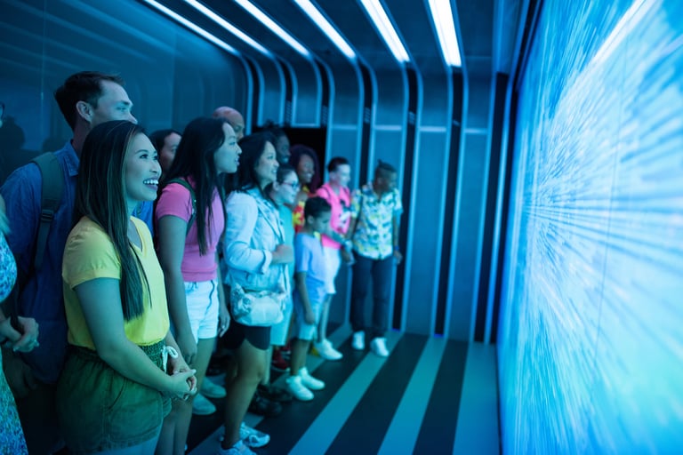 a group of people standing in a line of people watching a video