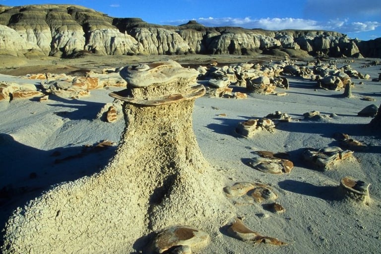 a rock formation in the desert with a blue sky