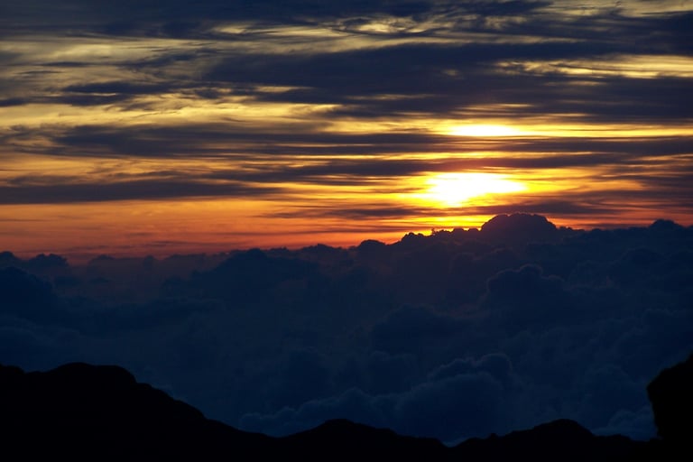 a sunrise with a sun rising over a mountain range