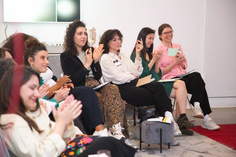 Young professional women applauding in workshop setting
