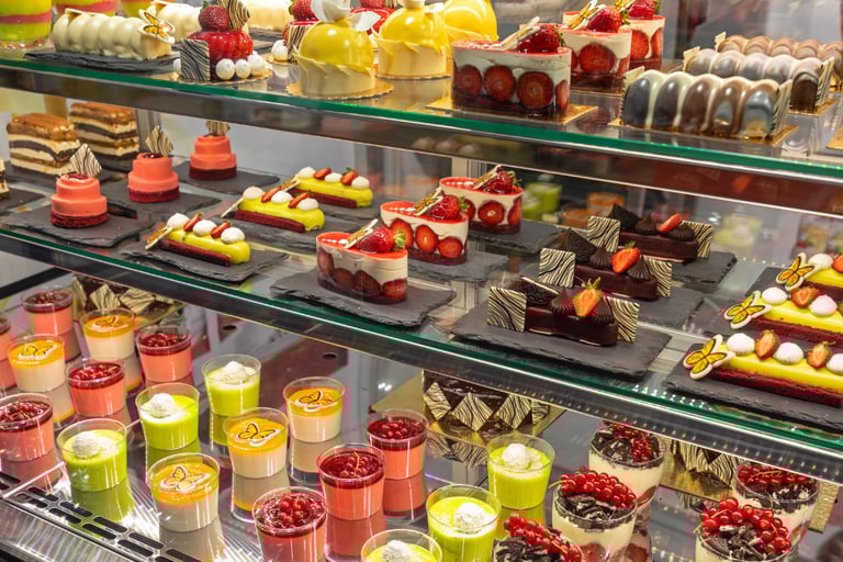 assorted dairy desserts and pastries in display case
