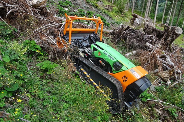 Green Climber LV 800 Pro Model clearing dense brush and logs up steep slope in forested area