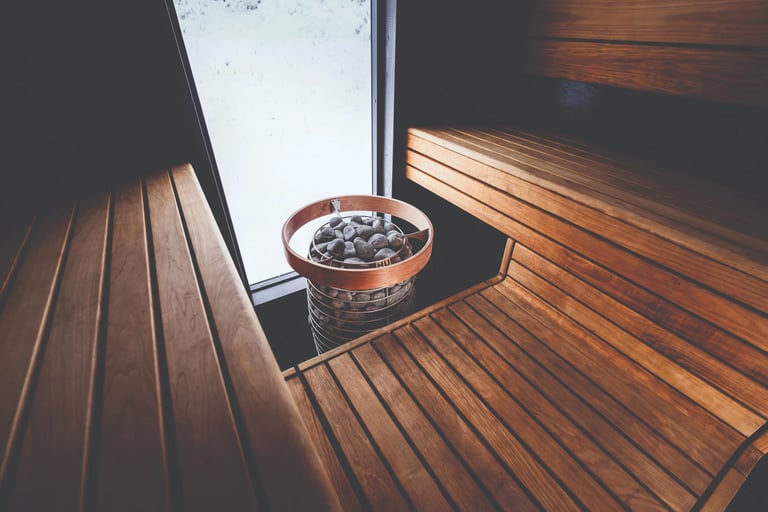 Cedar sauna interior with benches and warm window light in an Outdoor sauna Ontario design