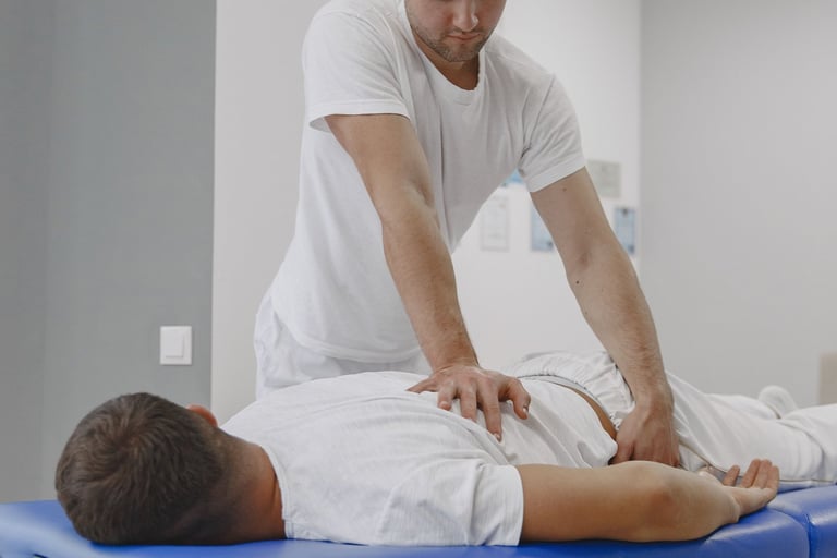 Chiropractor performing lower back adjustment in Brookfield WI