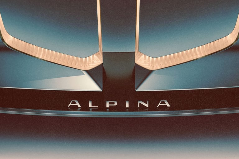 Close-up of a luxury Alpina car front bumper featuring silver lettering and elegant gold trim accents.