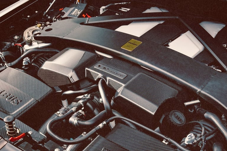 Detailed close-up of a high-performance Brabus carbon fiber engine bay and strut bar.