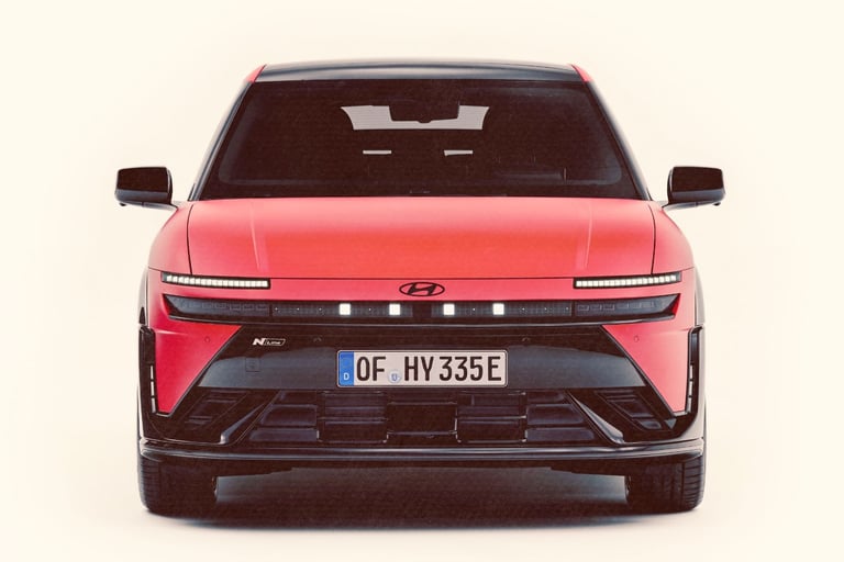 Front view of a red Hyundai IONIQ 3 N Line electric car with pixel LED headlights.