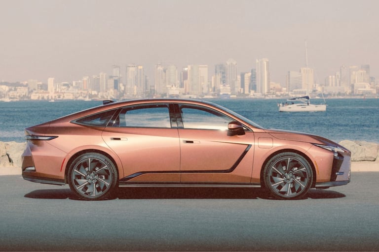 lexus es metallic bronze sedan parked on a coastal road with a city skyline and ocean background.