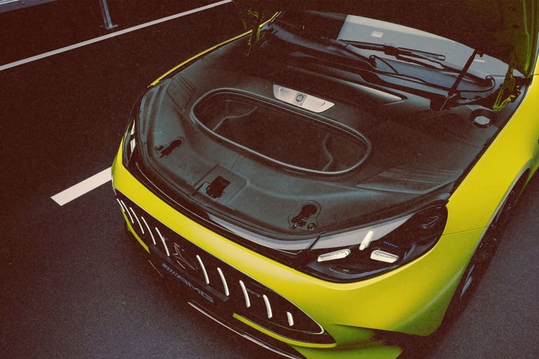 High-angle view of a lime green Mercedes-AMG electric car with its front trunk storage open.