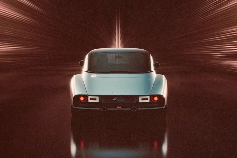 Rear view of a silver Morgan Supersports car driving through a high-speed motion blur tunnel.