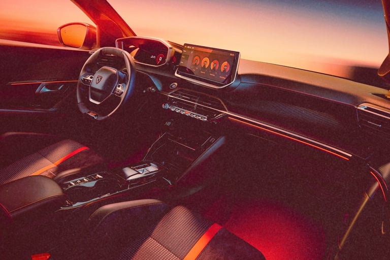 Modern car interior with digital dashboard and touchscreen display illuminated by orange sunset light.