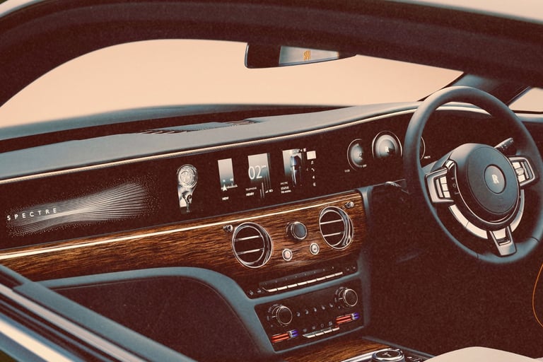 Luxury interior of a Rolls-Royce Spectre showing the wood dashboard, digital display, and steering wheel.
