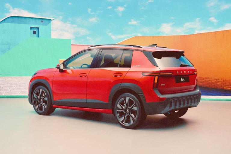 Red Skoda Epiq electric compact SUV parked in front of colorful modern architecture under a blue sky.