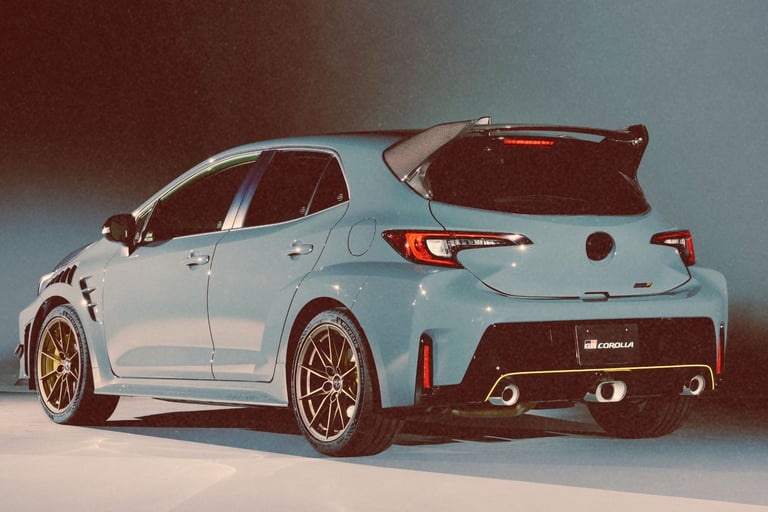 A light blue Toyota GR Corolla hatchback with a carbon fiber rear spoiler and performance alloy wheels.