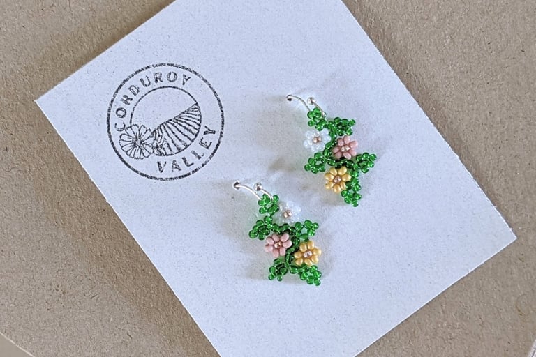 Beautifully hand beaded soft pink, soft mustard, and pearl white floral garland earrings made with Czech glass beads