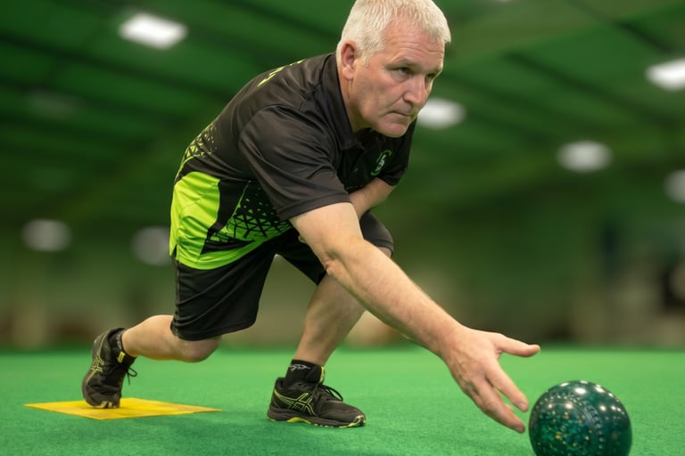 Bowler releasing the bowl on an indoor mat