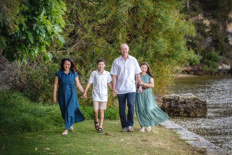 A Family of four walking along the foreshore Minim Cove by Fisher Photography