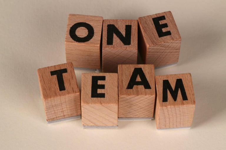 Blocks spelling 'ONE TEAM', symbolizing teamwork, collaboration, and alignment