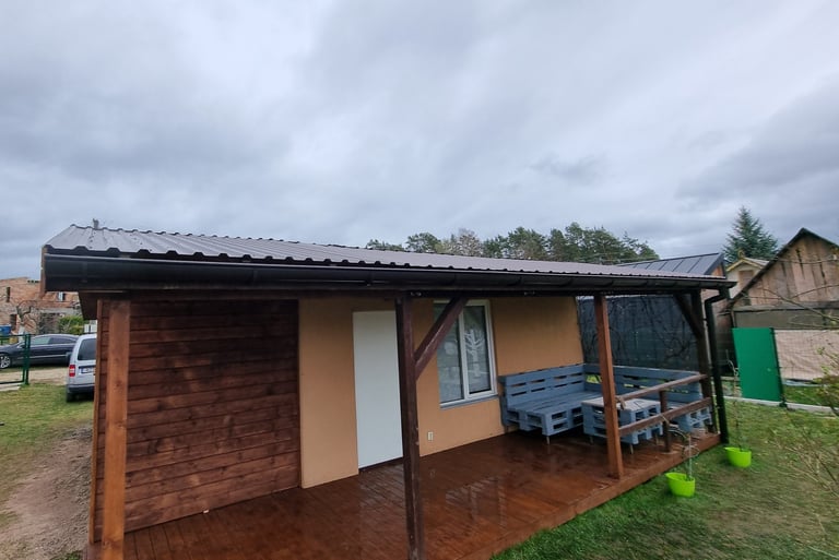 a small house with a bench and a bench in the yard