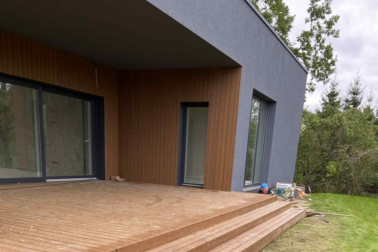 a wooden deck with a bucket of water and a bucket of water