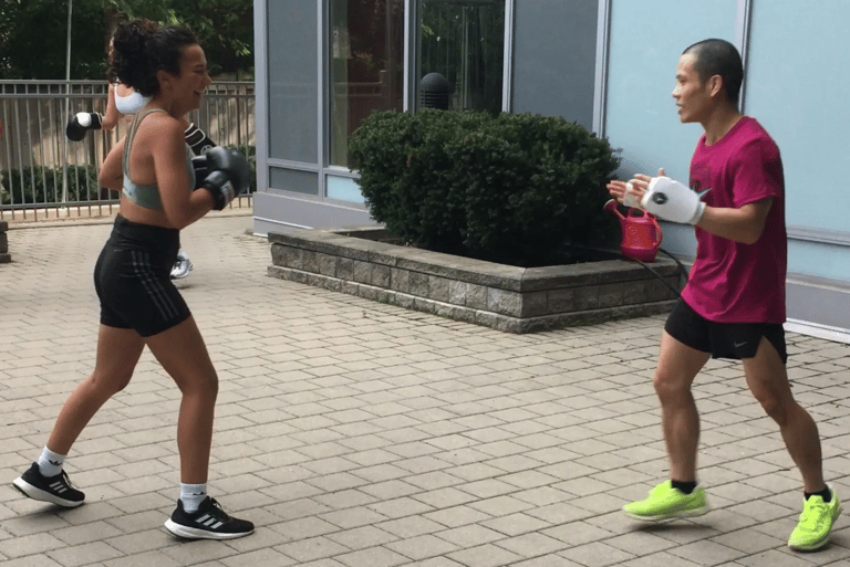 A man and woman are exercising in a gym.