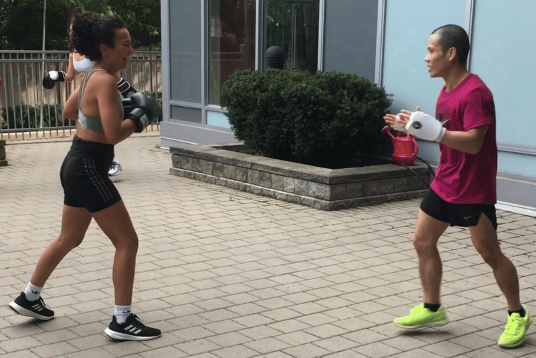 A man and woman are exercising in a gym.