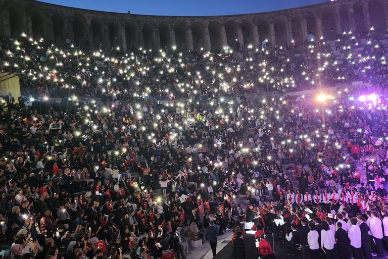 a large crowd of people standing in front of a stage