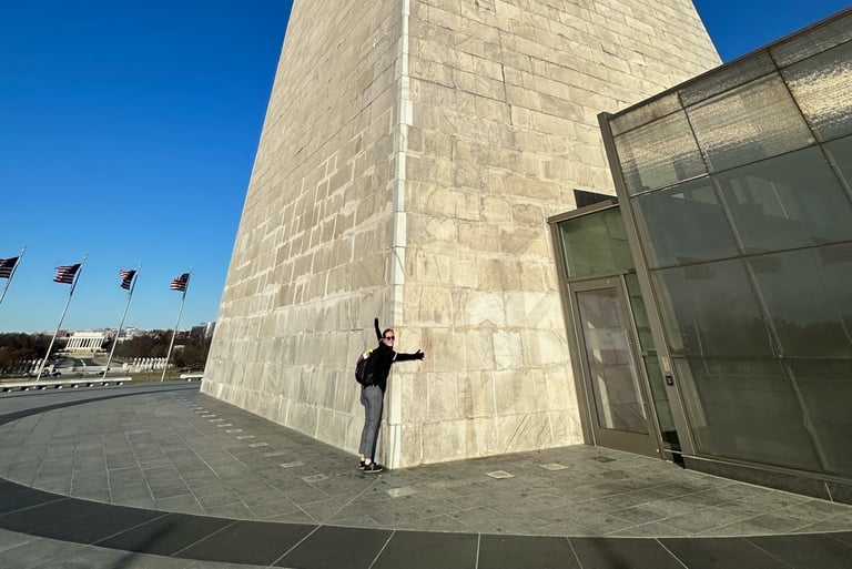 A normal sized person holding the Washington monument. There are substantial size difference between