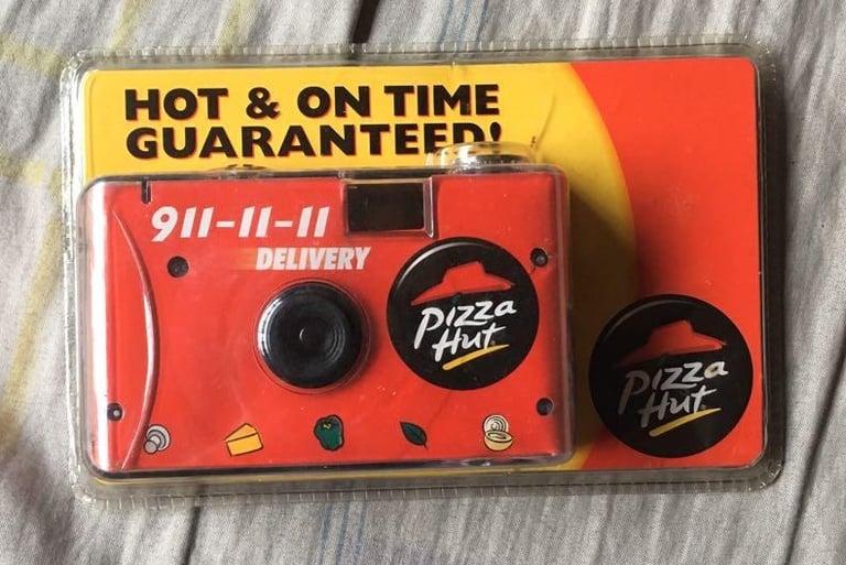 A packaged disposable film camera, in Pizza Hut's iconic colors and logo.