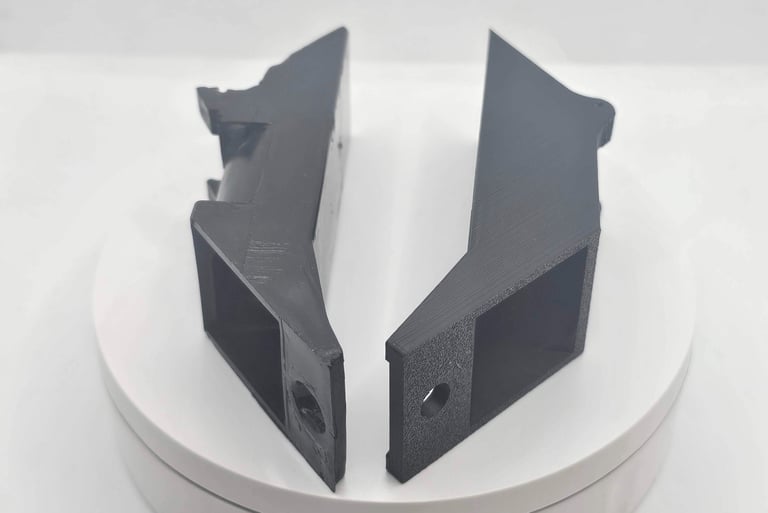 a pair of black and white plastic brackets