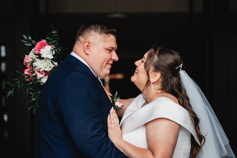 a bride and groom standing in front of a doorway
