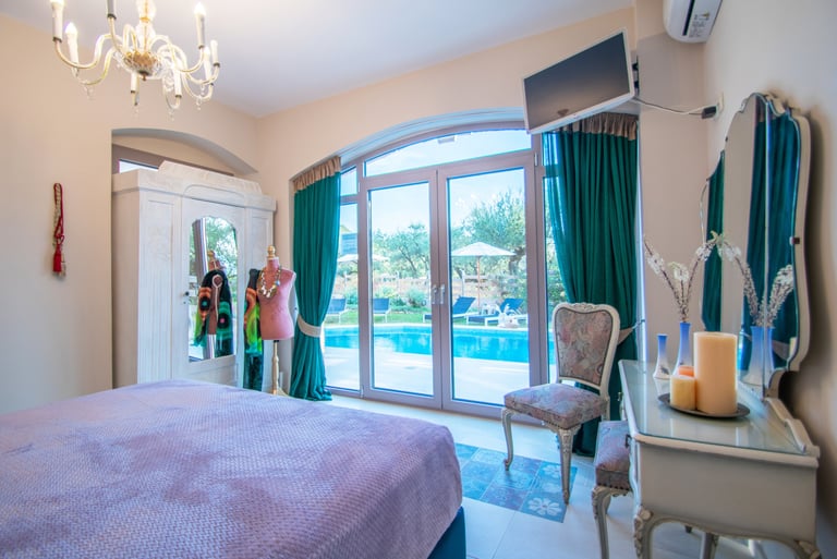 a bedroom with a queen size bed and a pool view