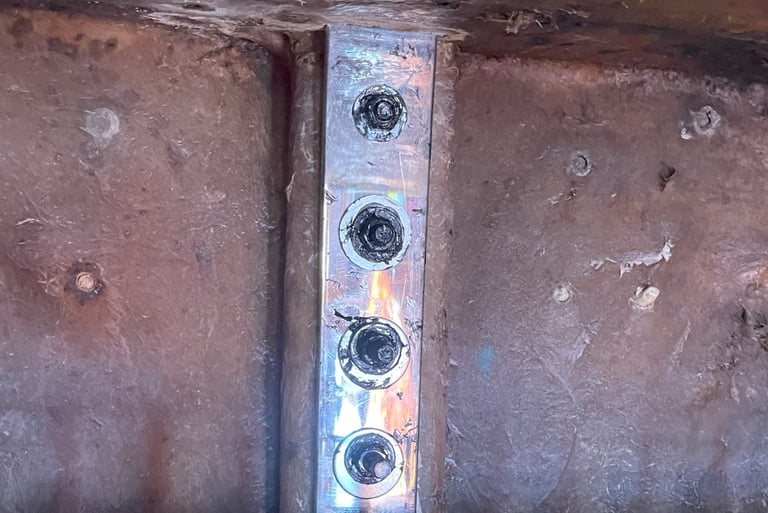 Newly mounted chainplate in sailboat showing clean installation