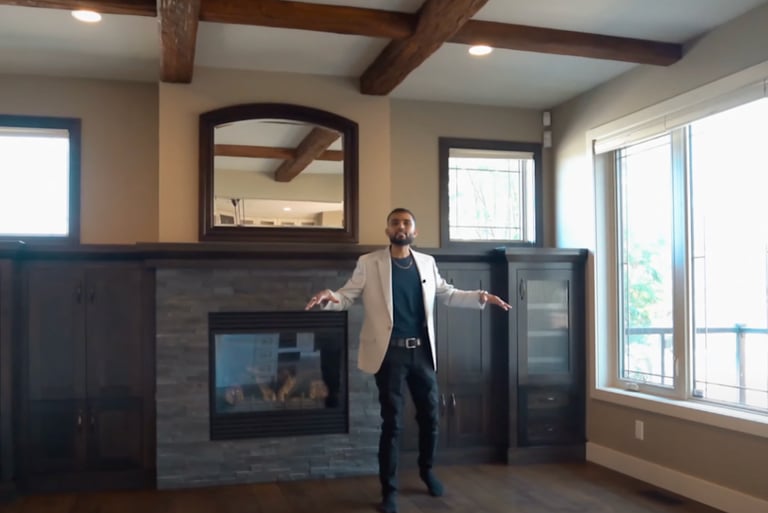 a man standing in a room with a fireplace