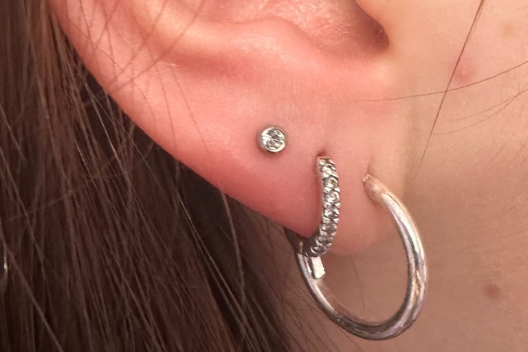 Professional lobe piercing with titanium stud in Montrose