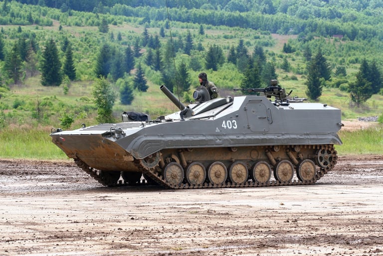 a tank - BMP-1 tank sitting on a dirt road