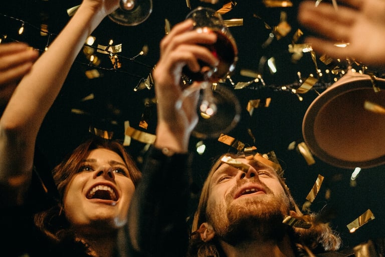 a group of people standing around a table with champagne glasses
